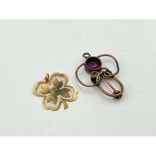 2028 - Two unmarked yellow metal pendants, one Art Nouveau amethyst and seed pearl lavalier and one four le... 