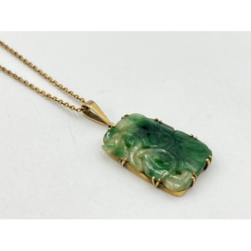 2029 - A yellow metal jade pendant on 9ct gold necklace - approx. gross chain weight 1.8g and pendant 4.7g