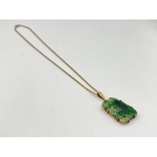 2029 - A yellow metal jade pendant on 9ct gold necklace - approx. gross chain weight 1.8g and pendant 4.7g