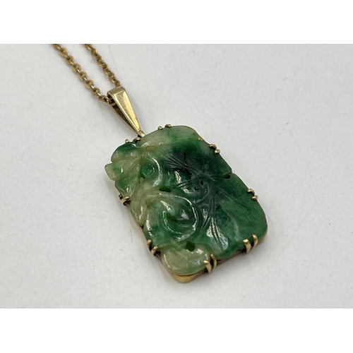 2029 - A yellow metal jade pendant on 9ct gold necklace - approx. gross chain weight 1.8g and pendant 4.7g