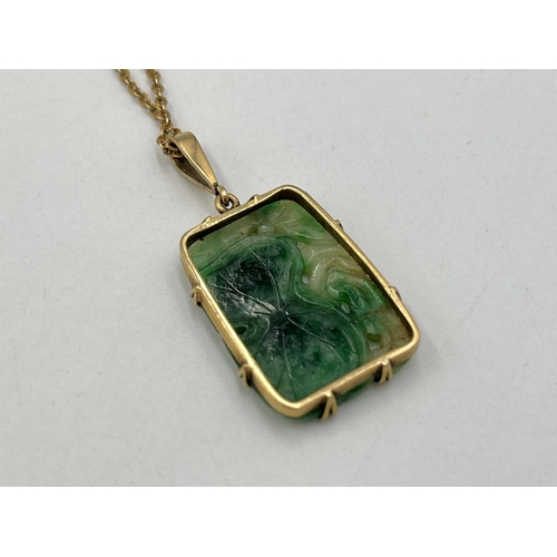 2029 - A yellow metal jade pendant on 9ct gold necklace - approx. gross chain weight 1.8g and pendant 4.7g