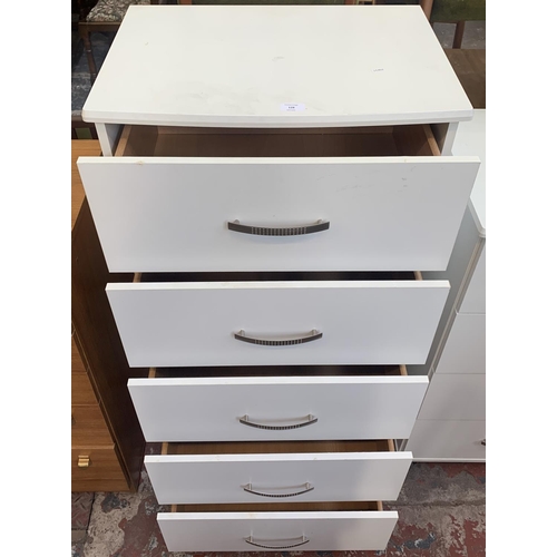 128 - A modern white laminate chest of drawers - approx. 122cm high x 60cm wide x 43cm deep