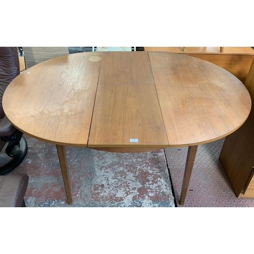 132 - A mid 20th century teak extending dining table - approx. 74cm high x 117cm wide x 155cm long