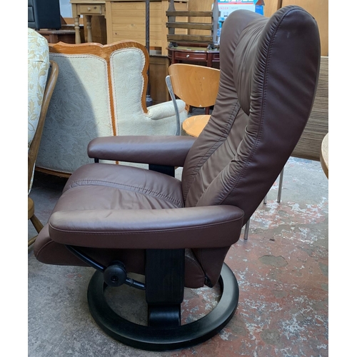 133 - An Ekornes Stressless brown leather and ebonised bentwood swivel reclining armchair and two footstoo... 