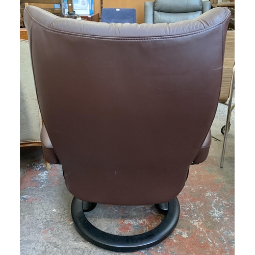 133 - An Ekornes Stressless brown leather and ebonised bentwood swivel reclining armchair and two footstoo... 