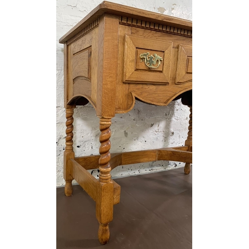 140 - A 19th century style oak three drawer writing desk on barley twist supports - approx. 76cm high x 90... 