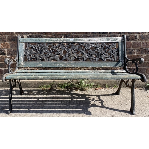 141 - A cast iron and wooden slatted garden bench - approx. 74cm high x 127cm wide x 50cm deep