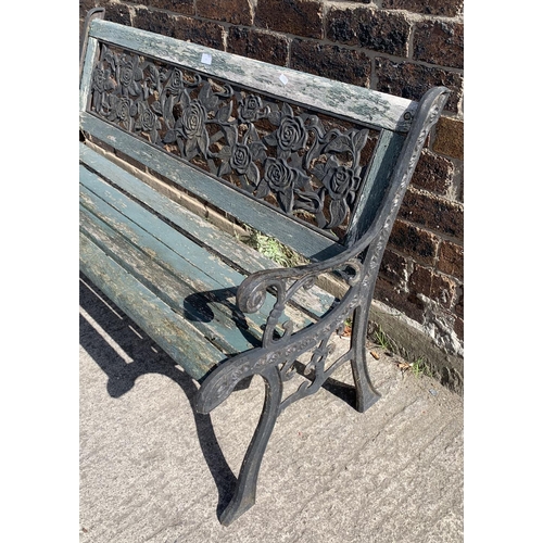 141 - A cast iron and wooden slatted garden bench - approx. 74cm high x 127cm wide x 50cm deep