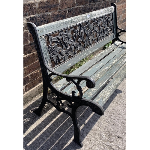 141 - A cast iron and wooden slatted garden bench - approx. 74cm high x 127cm wide x 50cm deep