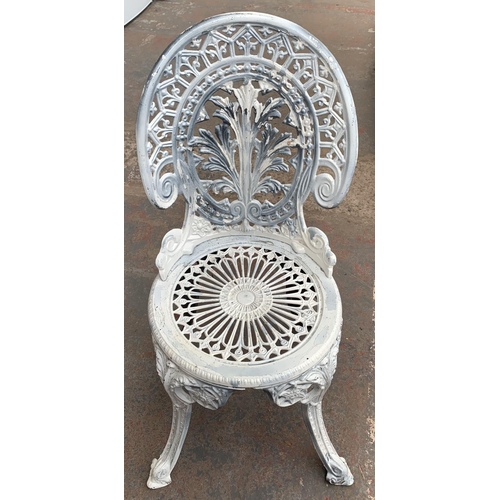 144 - A Victorian style cast metal three piece patio set comprising circular table and two chairs - table ... 