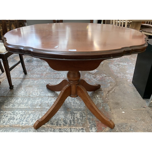 148 - A Rossmore Furniture cherry wood serpentine extending table - approx. 76cm high x 108cm diameter