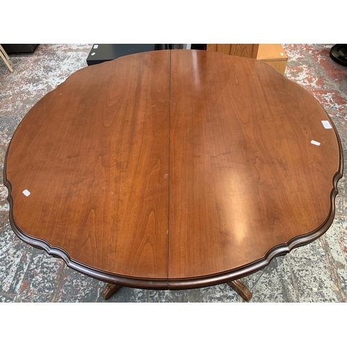 148 - A Rossmore Furniture cherry wood serpentine extending table - approx. 76cm high x 108cm diameter