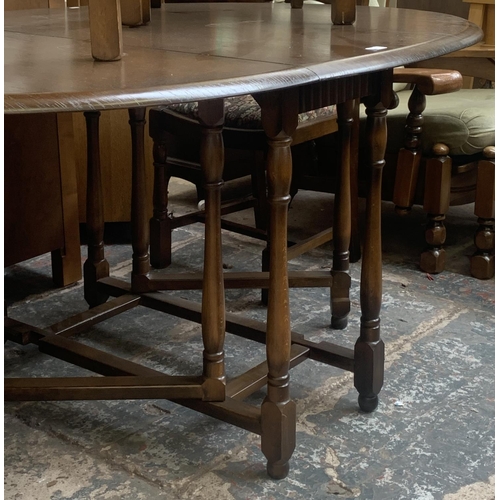 56 - A Priory oak drop leaf gate leg dining table and four ladder back chairs - approx. 76cm high x 112cm... 