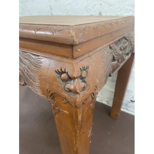 62 - A Chinese carved hardwood side table - approx. 47cm high x 40cm wide x 53cm long