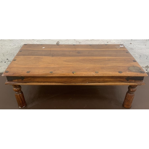 64 - An Indian sheesham wood rectangular coffee table - approx. 40cm high x 60cm wide x 110cm long