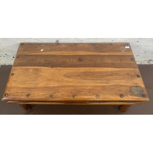 64 - An Indian sheesham wood rectangular coffee table - approx. 40cm high x 60cm wide x 110cm long