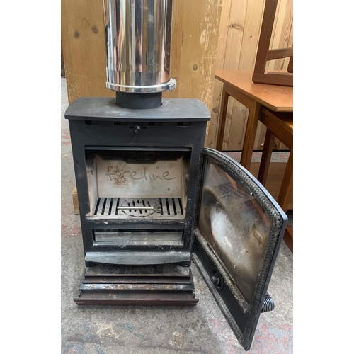 76 - A Fireline cast iron freestanding stove with Duoten 1000mm conduit - approx. 197cm high