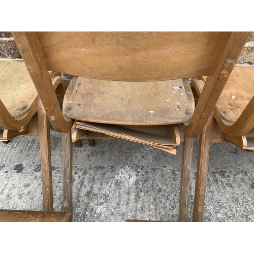 81 - Seven mid 20th century beech and plywood stacking chairs