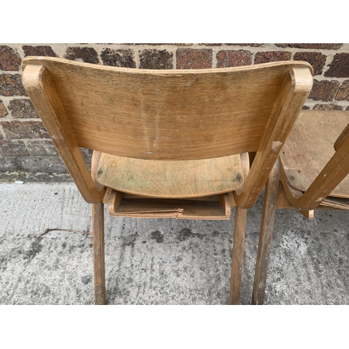 81 - Seven mid 20th century beech and plywood stacking chairs