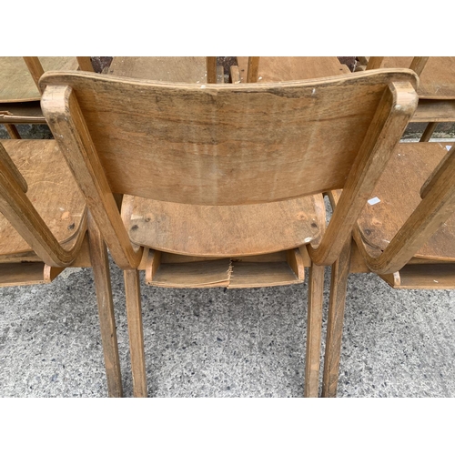 81 - Seven mid 20th century beech and plywood stacking chairs