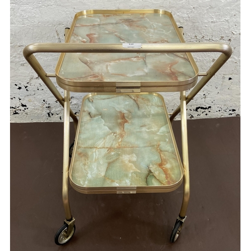 110 - A mid 20th century onyx effect laminate and metal two tier tea trolley