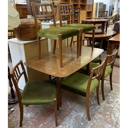 113 - A mid 20th century walnut and beech drop leaf gate leg dining table and six green fabric upholstered... 