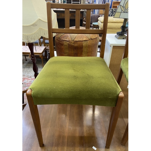 113 - A mid 20th century walnut and beech drop leaf gate leg dining table and six green fabric upholstered... 