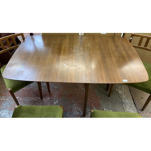 113 - A mid 20th century walnut and beech drop leaf gate leg dining table and six green fabric upholstered... 