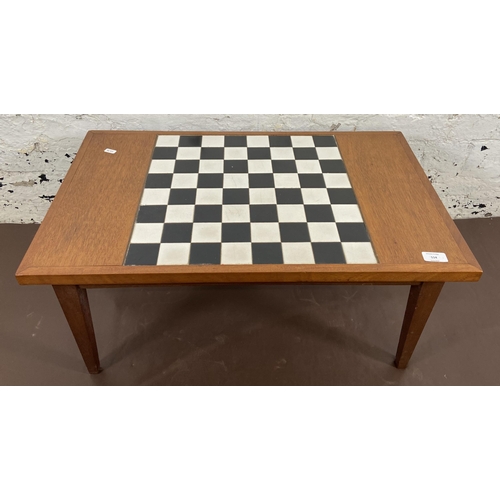 114 - A mid 20th century teak rectangular games table with ceramic tile inserts - approx. 34cm high x 45cm... 