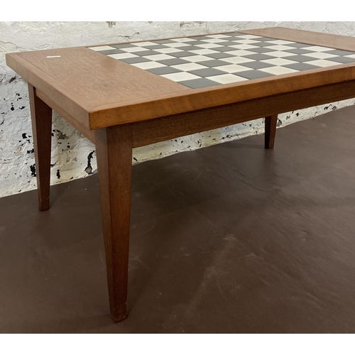 114 - A mid 20th century teak rectangular games table with ceramic tile inserts - approx. 34cm high x 45cm... 