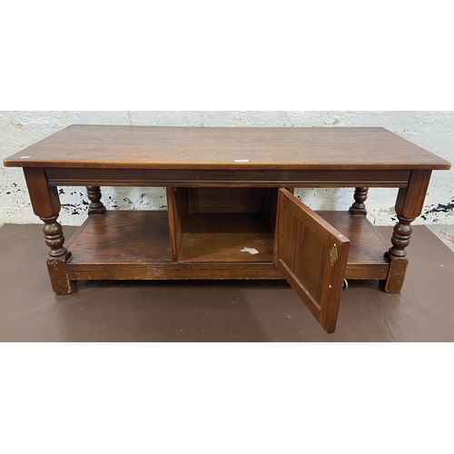 121 - An Old Charm carved oak rectangular coffee table with linenfold cupboard door - approx. 46cm high x ... 