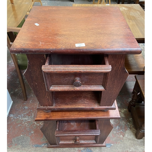 123 - A pair of stained oak magazine rack side tables - approx. 49cm high x 51cm wide x 46cm deep