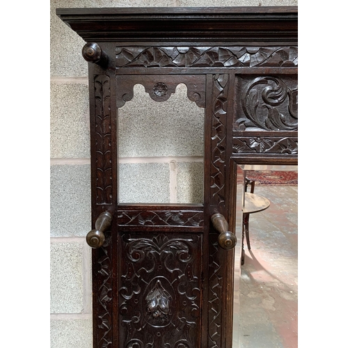 2 - A Victorian Gothic Revival carved oak hall stand with Green Man design and central bevelled edge mir... 