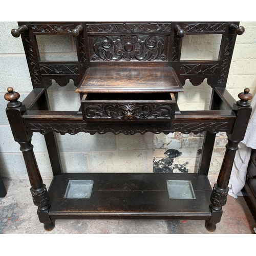 2 - A Victorian Gothic Revival carved oak hall stand with Green Man design and central bevelled edge mir... 