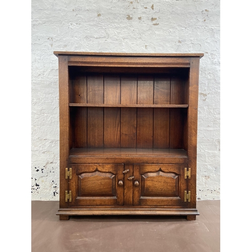 20 - A Titchmarsh & Goodwin oak two tier bookcase with brass 