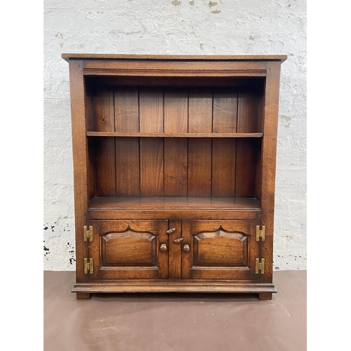 20 - A Titchmarsh & Goodwin oak two tier bookcase with brass 