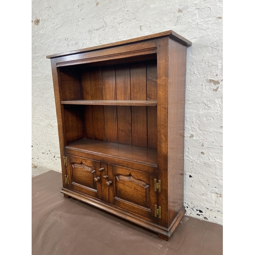 20 - A Titchmarsh & Goodwin oak two tier bookcase with brass 