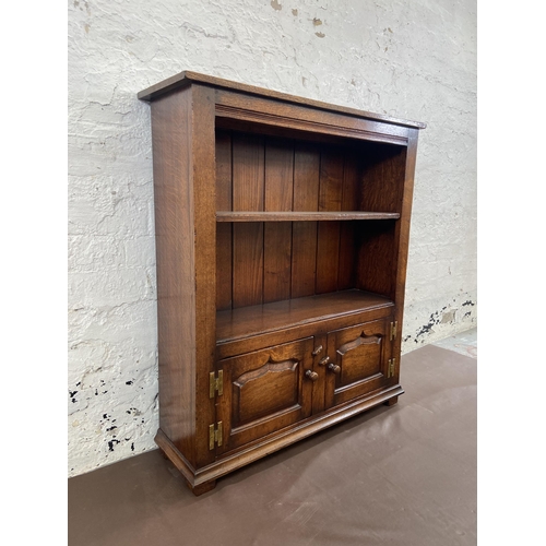 20 - A Titchmarsh & Goodwin oak two tier bookcase with brass 