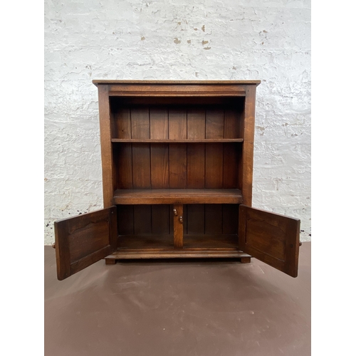 20 - A Titchmarsh & Goodwin oak two tier bookcase with brass 