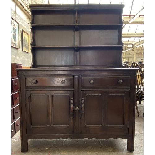 24 - An Ercol Old Colonial elm dresser - approx. 160cm high x 123cm wide x 47cm deep