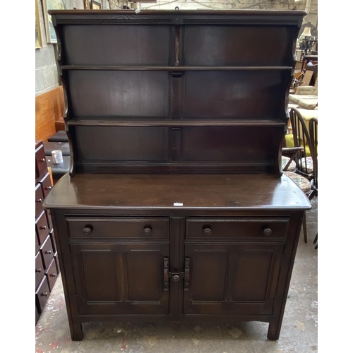 24 - An Ercol Old Colonial elm dresser - approx. 160cm high x 123cm wide x 47cm deep