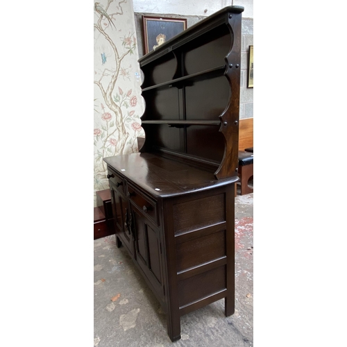 24 - An Ercol Old Colonial elm dresser - approx. 160cm high x 123cm wide x 47cm deep