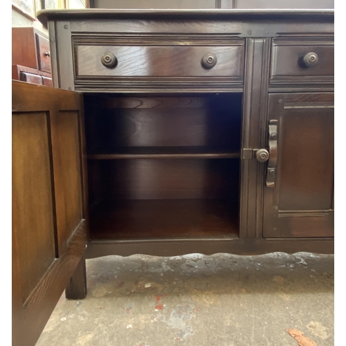 24 - An Ercol Old Colonial elm dresser - approx. 160cm high x 123cm wide x 47cm deep