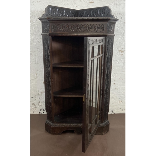 3 - A Victorian Gothic Revival carved oak corner display cabinet - approx. 117cm high x 67cm wide x 43cm... 