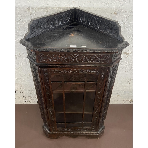 3 - A Victorian Gothic Revival carved oak corner display cabinet - approx. 117cm high x 67cm wide x 43cm... 