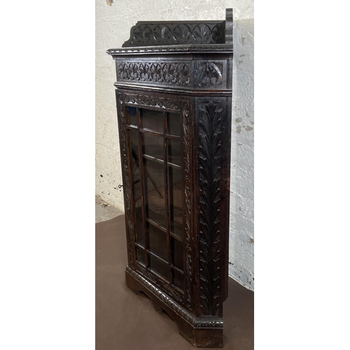 3 - A Victorian Gothic Revival carved oak corner display cabinet - approx. 117cm high x 67cm wide x 43cm... 