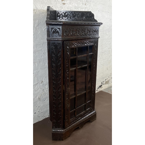 3 - A Victorian Gothic Revival carved oak corner display cabinet - approx. 117cm high x 67cm wide x 43cm... 