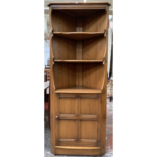 31 - An Ercol Golden Dawn elm free standing corner cabinet - approx. 184cm high