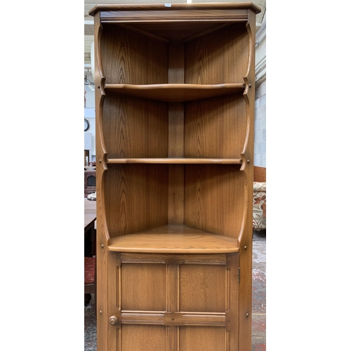 31 - An Ercol Golden Dawn elm free standing corner cabinet - approx. 184cm high