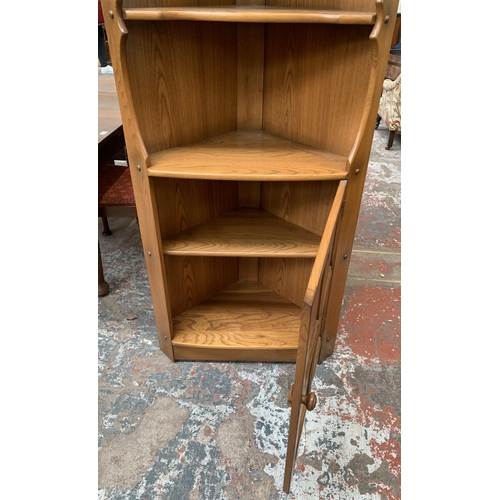 31 - An Ercol Golden Dawn elm free standing corner cabinet - approx. 184cm high